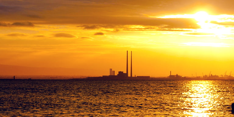 TCFD and the Evolution of Non-Financial Disclosure for PLCs image of Dublin bay and poolbeg at sunset