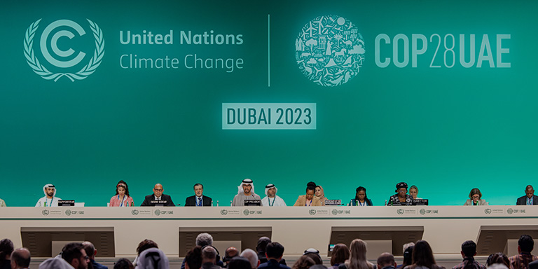 Annual sustainability event COP28 banner image of world leaders in the United Arab Emirates.