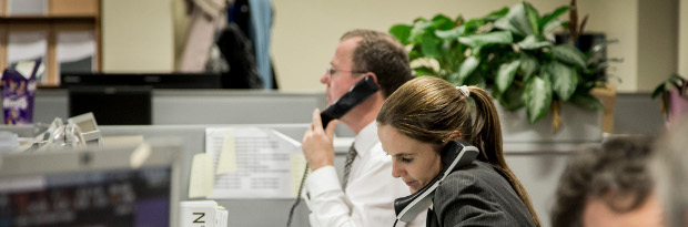 Photo of a man and a woman working at an execution desk.