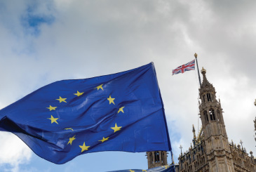 The EU flag against a backdrop of the UK flag