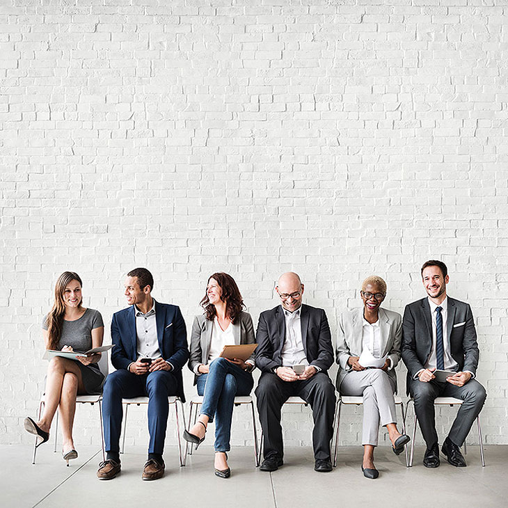 Community image of a group of happy people against a wall