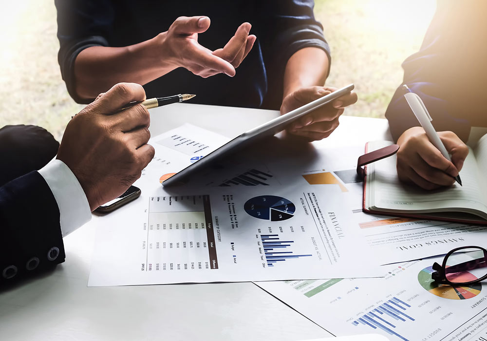 Business people communicating using notebook planning at a table meeting